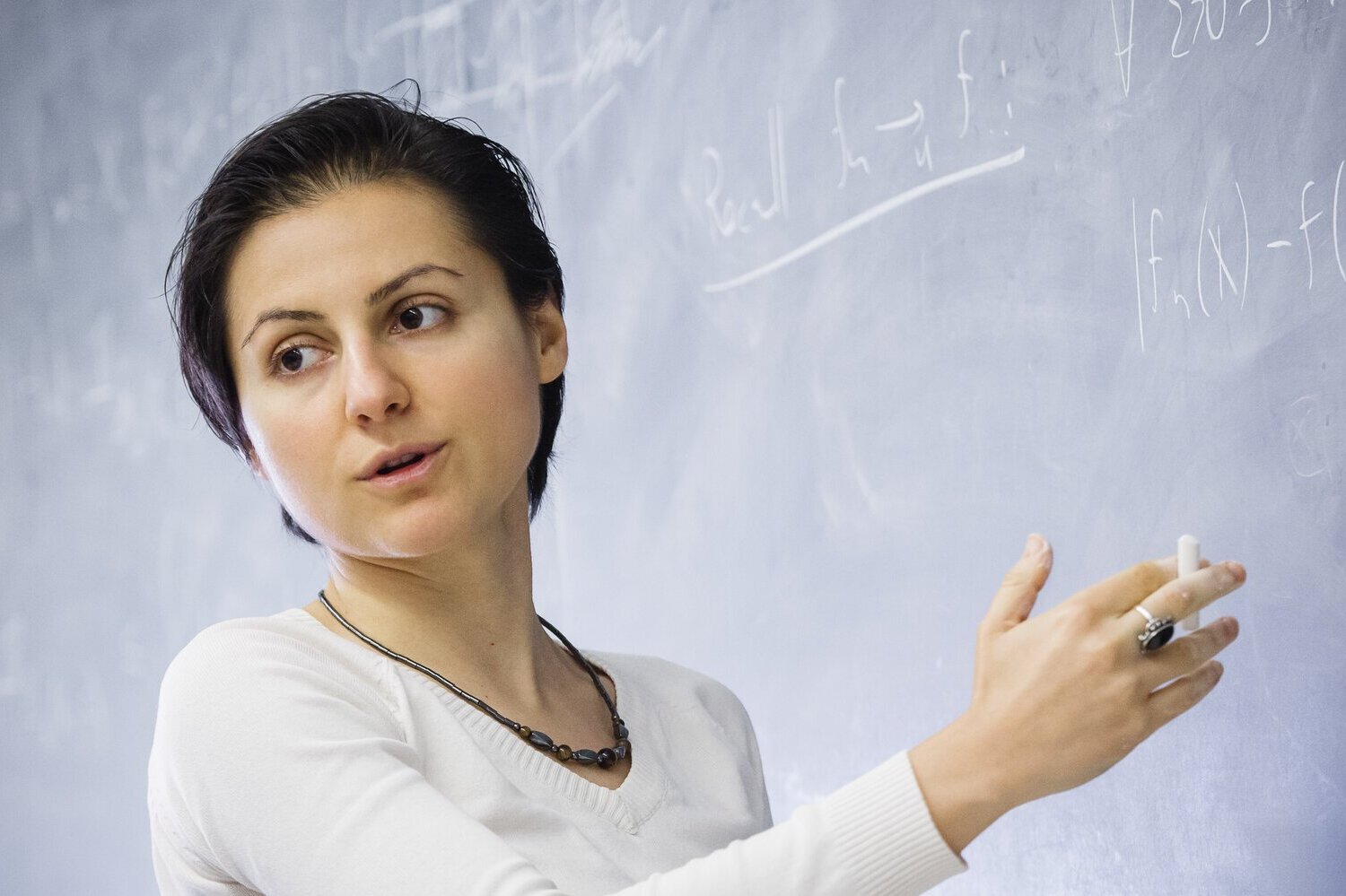 professor lecturing at blackboard